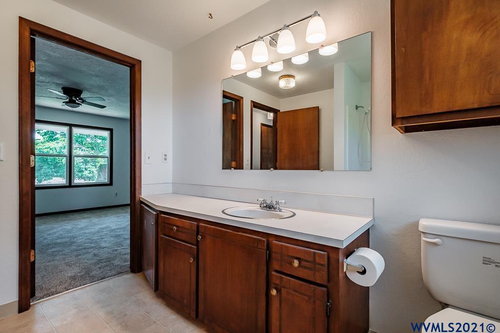 1278 Southwest Maple Street Dallas, OR 97338 - Photo 22 of 42 a bathroom with a toilet sink and mirror