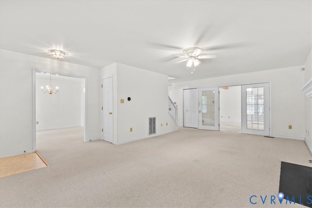 2924 Warfield Ridge Terrace Chester, VA 23831 - Photo 12 of 38 Expansive carpeted room featuring a ceiling fan, a
