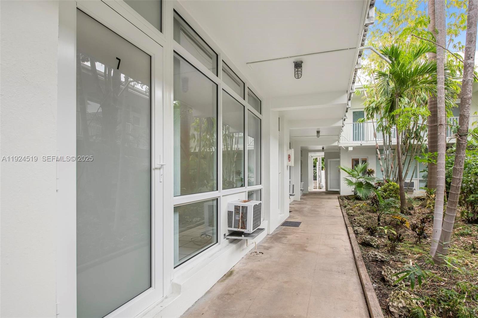 1850 Meridian Avenue, Unit 7 Miami Beach, FL 33139 - Photo 16 of 24 a view of a porch with plants and a potted plant