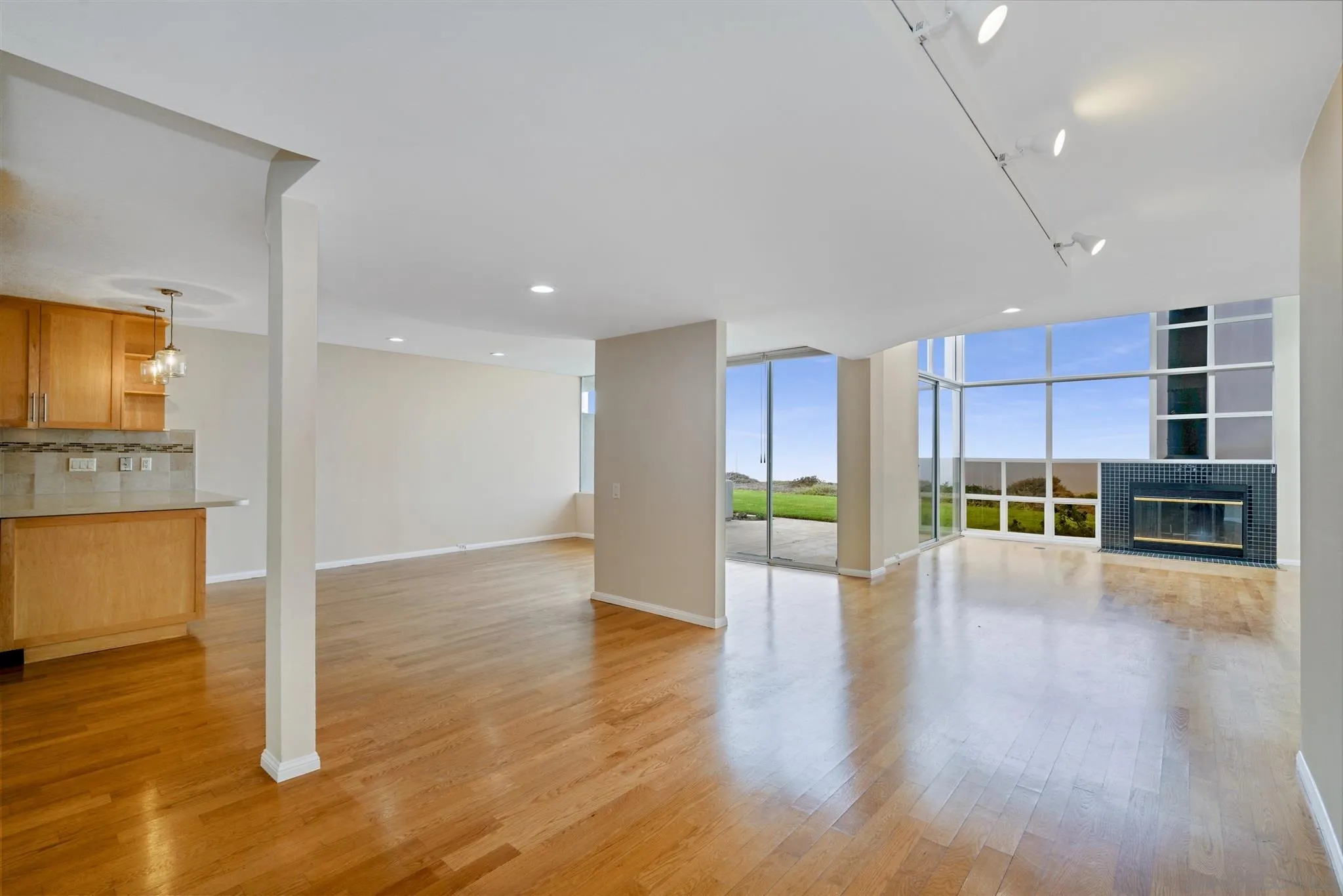 166 Solana Point Circle Solana Beach, CA 92075 - Photo 3 of 20 a view of an empty room with wooden floor and a kitchen