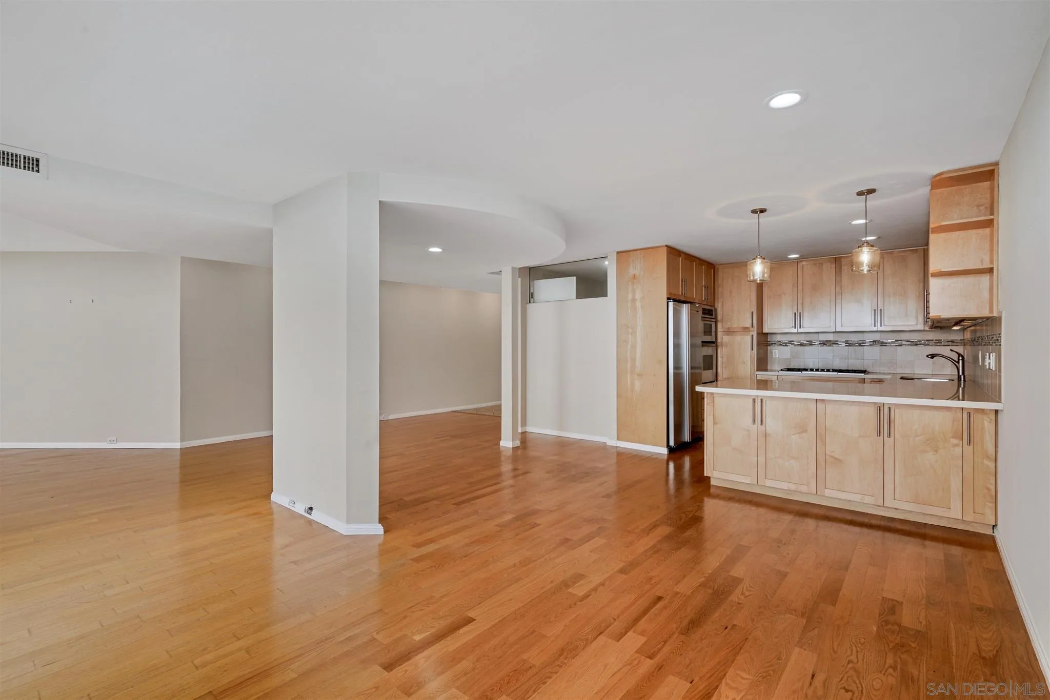 166 Solana Point Circle Solana Beach, CA 92075 - Photo 7 of 20 a kitchen with a refrigerator and white cabinets