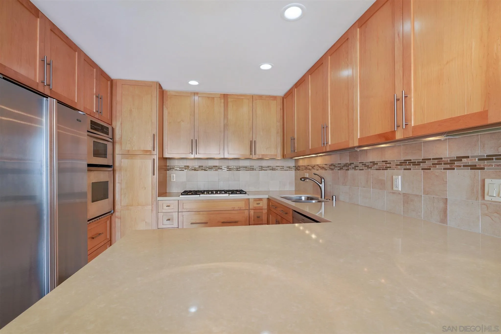 166 Solana Point Circle Solana Beach, CA 92075 - Photo 8 of 20 a kitchen with stainless steel appliances granite countertop a refrigerator sink and cabinets