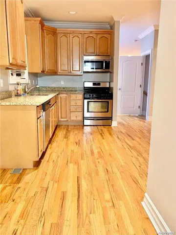 a kitchen with stainless steel appliances granite countertop a stove and a sink
