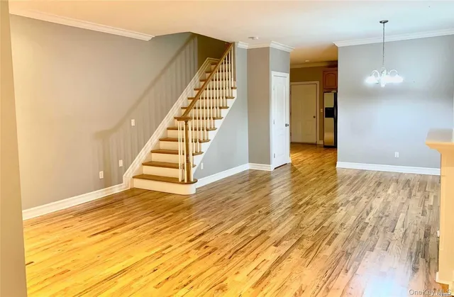 a view of a room with wooden floor and stairs