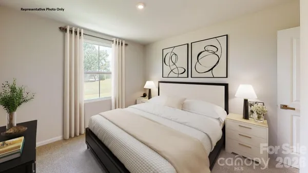 a bedroom with a bed and a potted plant