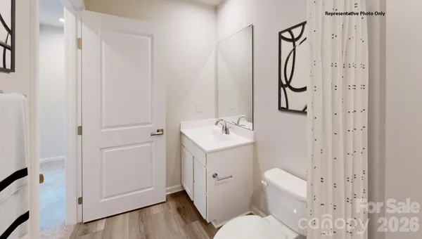 a white toilet sitting next to a bathroom sink