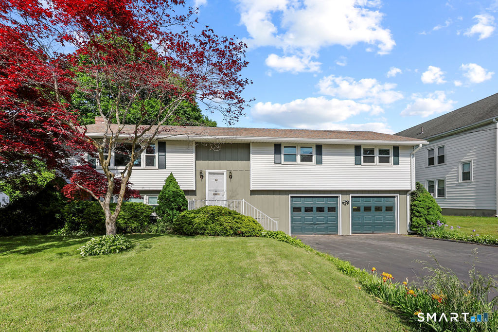 142 Wolcott Hill Road Wethersfield, CT 06109 - Photo 1 of 29 a front view of a house with a garden