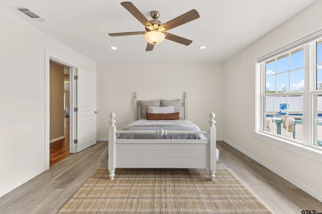 a bedroom with a bed and a window