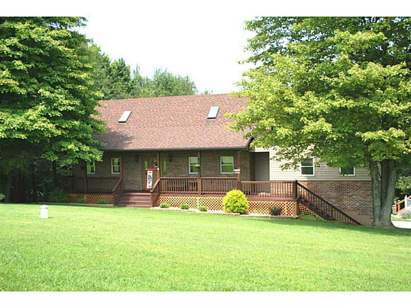 Exterior Front. Pretty brick 2-story capecod with covered front porch and huge addition! Tucked away in a private setting!