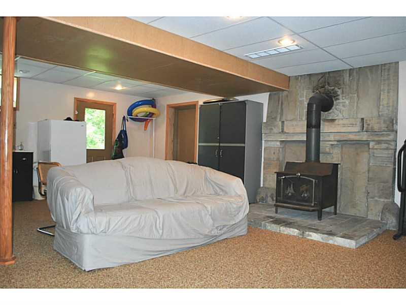141 Sportsman Lane Rochester, PA 15074 - Photo 16 of 25 Family Room. Lower level, walk-out family room with woodstove and beautiful stone wall. "Natural stone" flooring too!