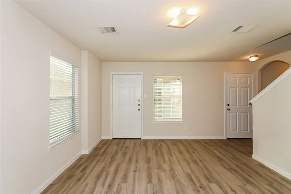 wooden floor in an empty room with a window