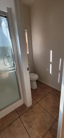 a bathroom with a toilet and a shower