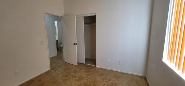 an empty room that has a window in it