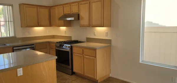 a kitchen with a sink and a stove top oven
