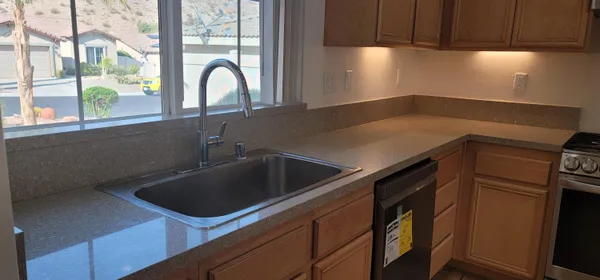 a kitchen with a sink cabinets and a window