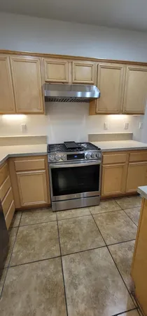 a kitchen with a stove and cabinets