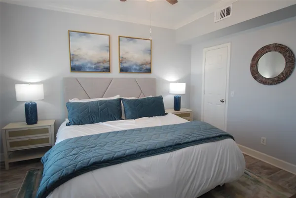 a bedroom with a bed and a lamp