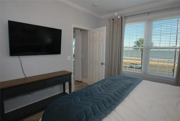 a living room with a flat screen tv and a window