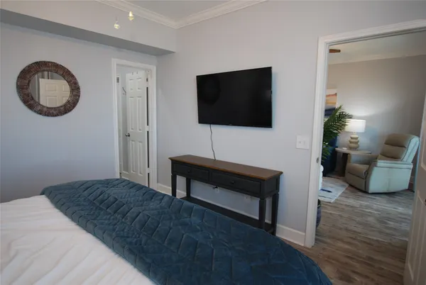 a bedroom with a bed and a flat screen tv