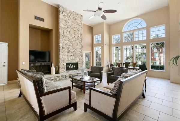 a living room with furniture a window and gym equipment