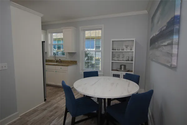 a view of a dining room with furniture and wooden floor