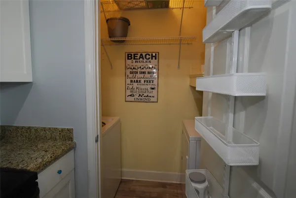 a bathroom with a granite countertop sink and a toilet