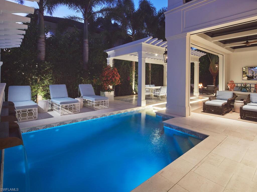 167 4th Street North Naples, FL 34102 - Photo 29 of 33 a view of pool with dining area and chandelier