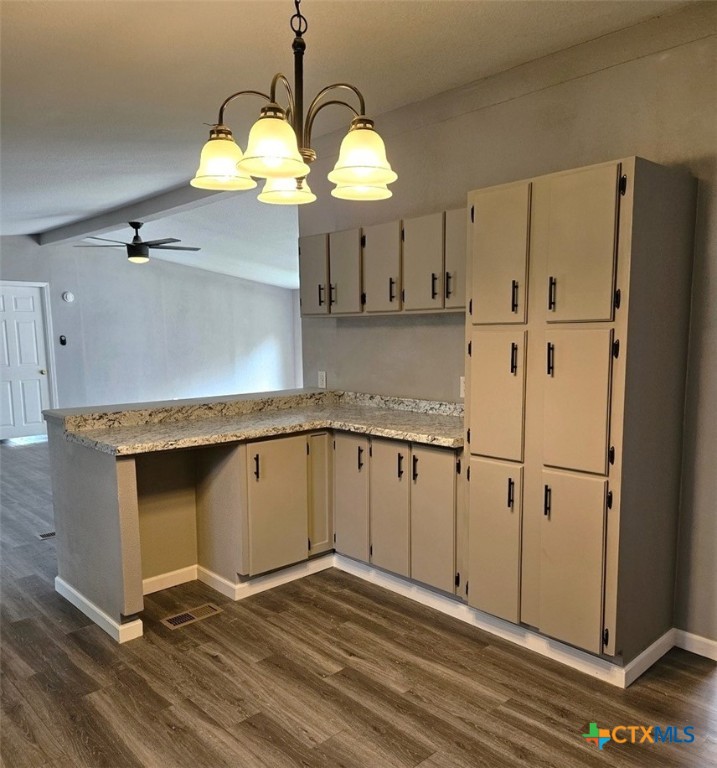 32 Briarwood Road Belton, TX 76513 - Photo 7 of 21 a kitchen with granite countertop a stove a sink and a chandelier