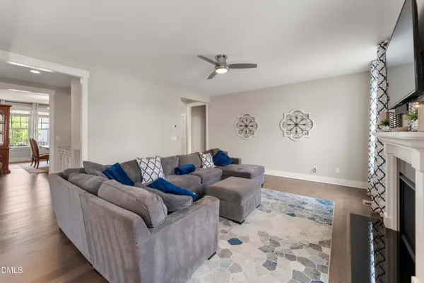 a living room with furniture a fireplace and a flat screen tv