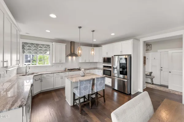a kitchen with center island table and chairs in it