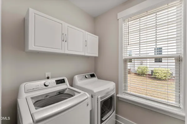 a spacious bedroom with a bed and a chandelier