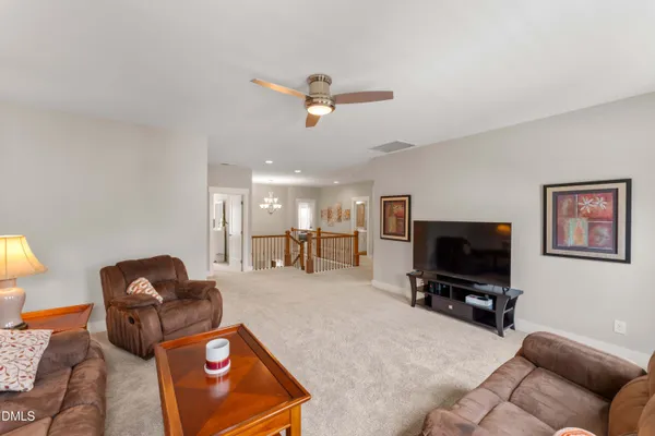 a spacious bedroom with a bed and a chair