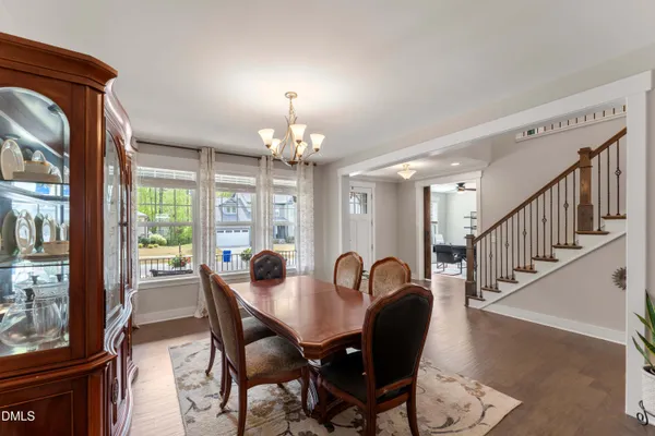 a view of a dining room with furniture wooden floor and chandelier