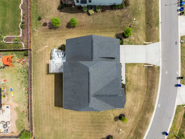 a balcony view with a couch and table and chairs