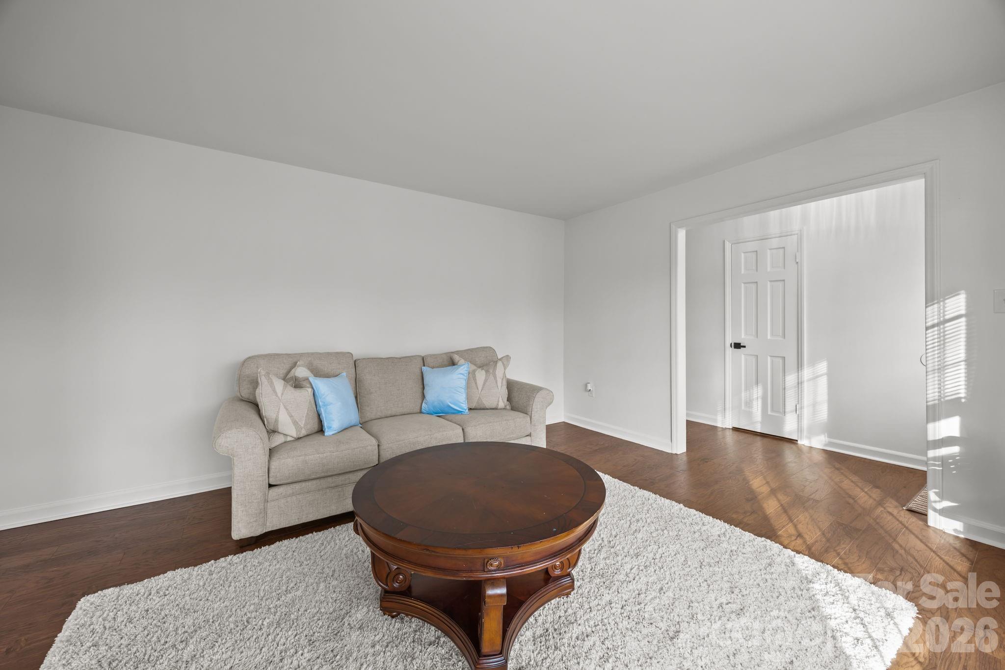 2431 Fox Hollow Road Mint Hill, NC 28227 - Photo 14 of 30 a living room with furniture a wooden floor and next to a window