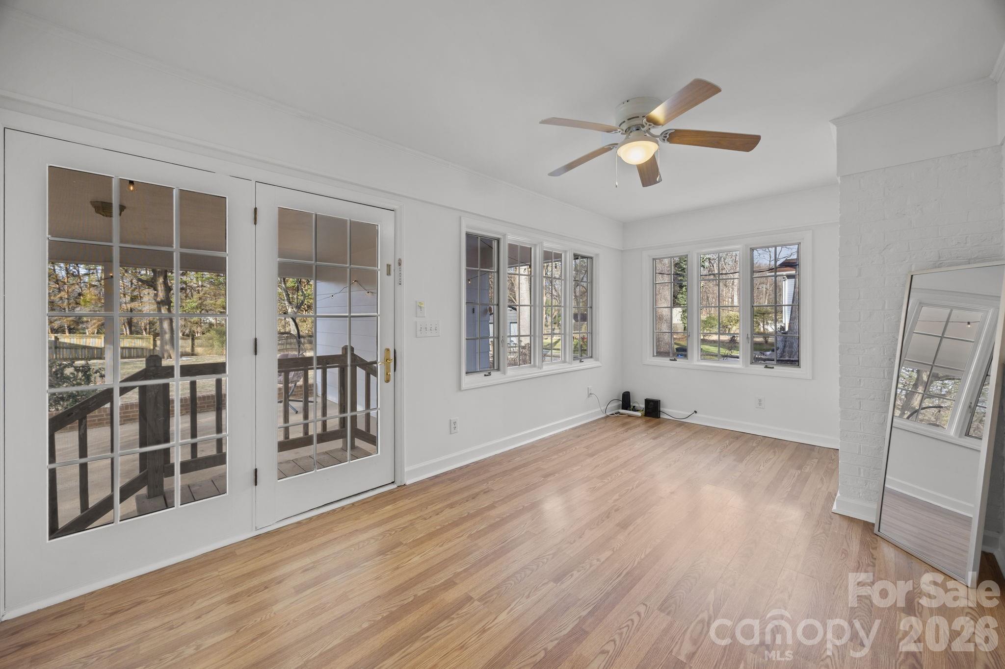 2431 Fox Hollow Road Mint Hill, NC 28227 - Photo 15 of 30 a view of an empty room with wooden floor and a window