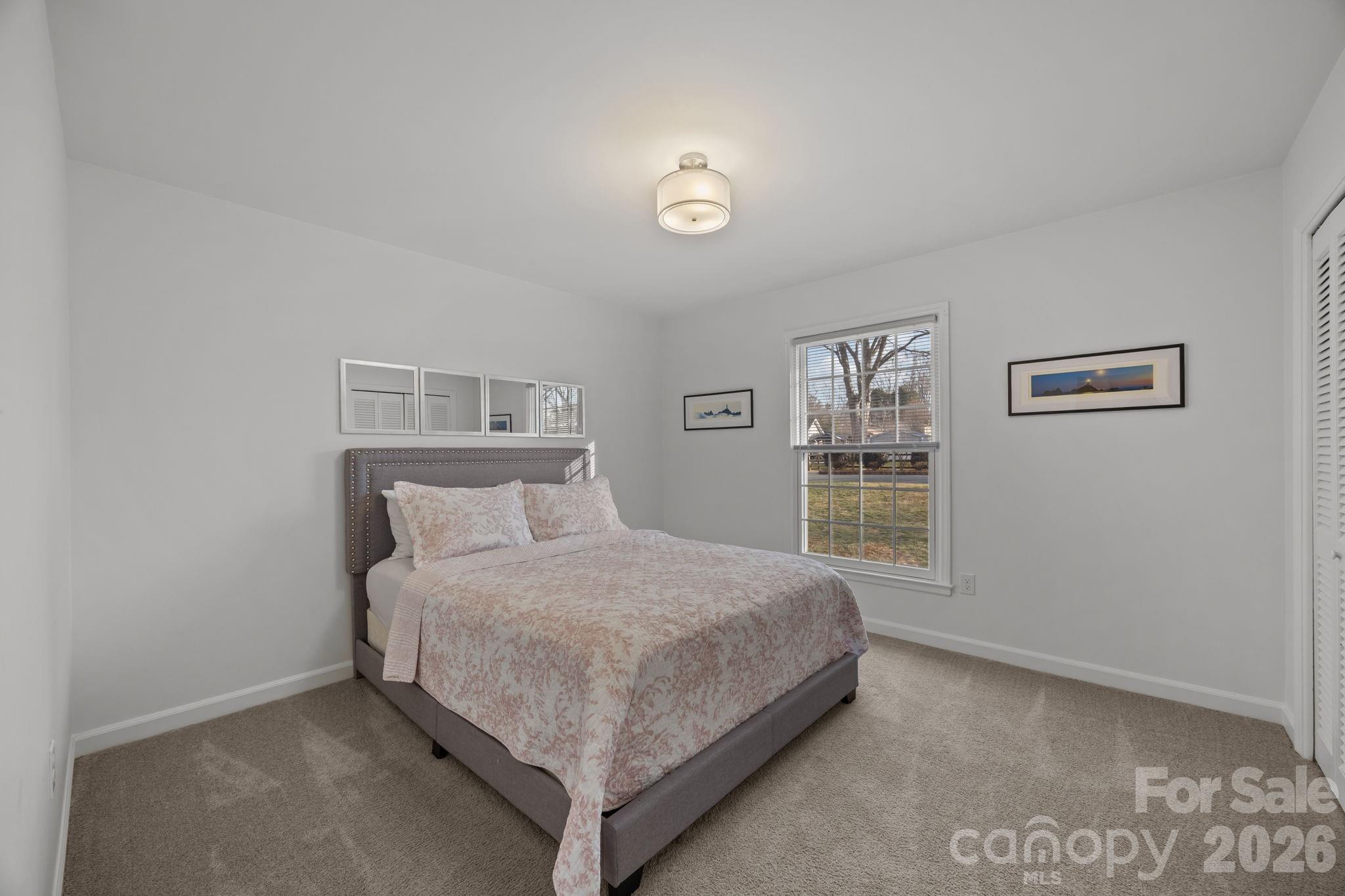 2431 Fox Hollow Road Mint Hill, NC 28227 - Photo 18 of 30 a bedroom with a bed and a window