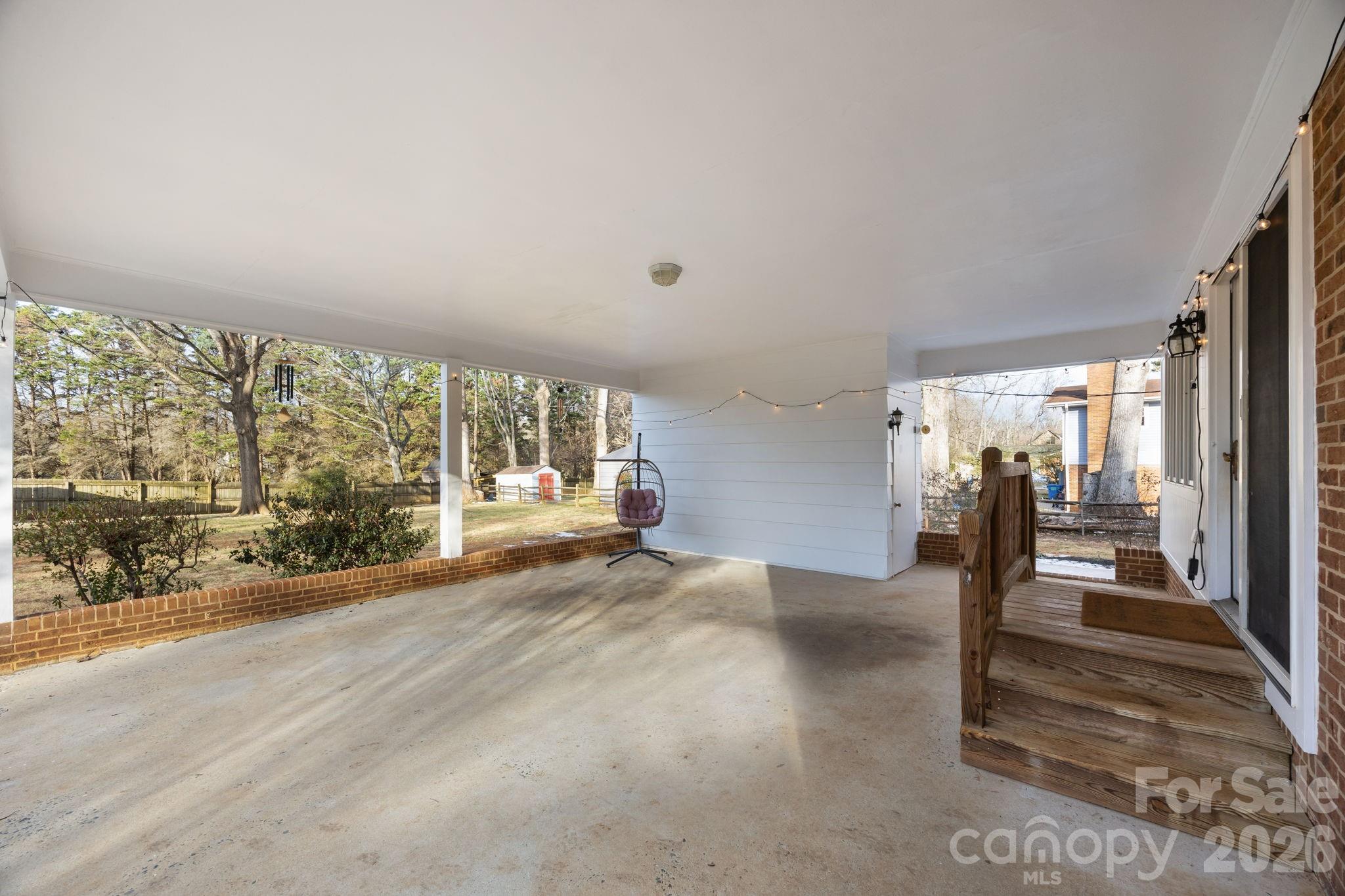 2431 Fox Hollow Road Mint Hill, NC 28227 - Photo 23 of 30 a view of empty room with wooden floor and floor to ceiling window