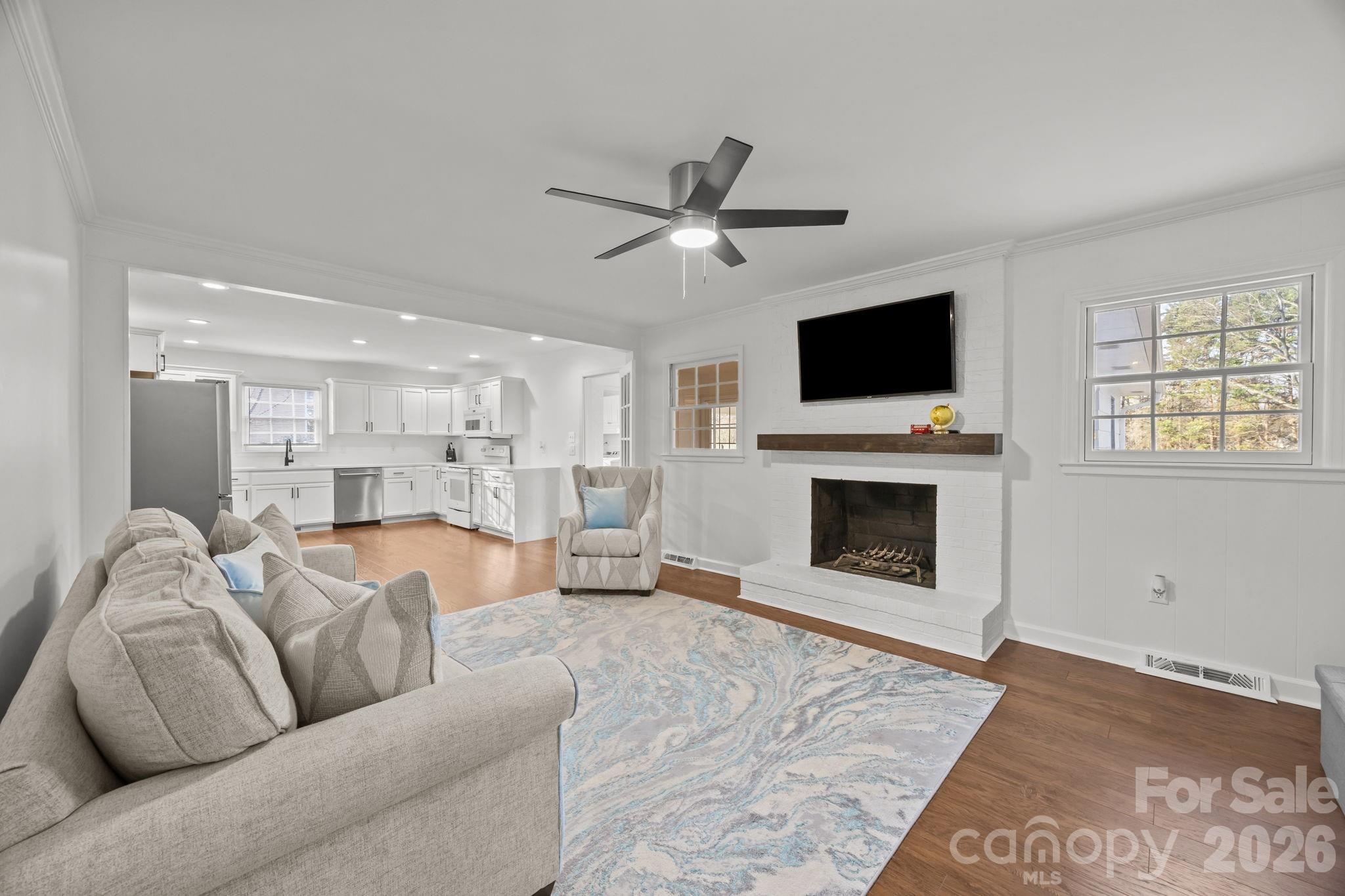 2431 Fox Hollow Road Mint Hill, NC 28227 - Photo 4 of 30 a living room with furniture a fireplace and a flat screen tv
