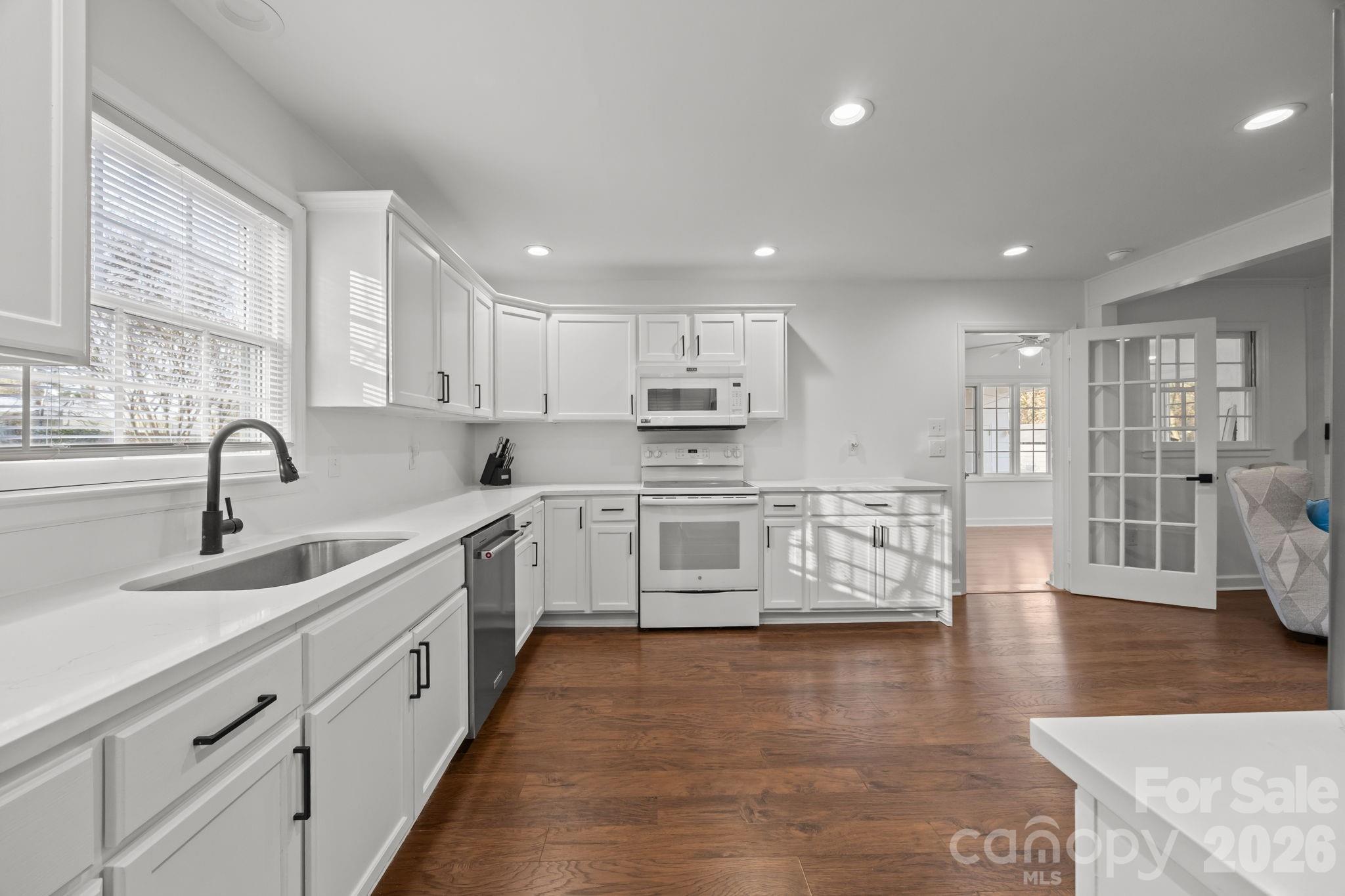 2431 Fox Hollow Road Mint Hill, NC 28227 - Photo 10 of 30 a large kitchen with stainless steel appliances granite countertop a large counter top a sink a stove a dining table and chairs