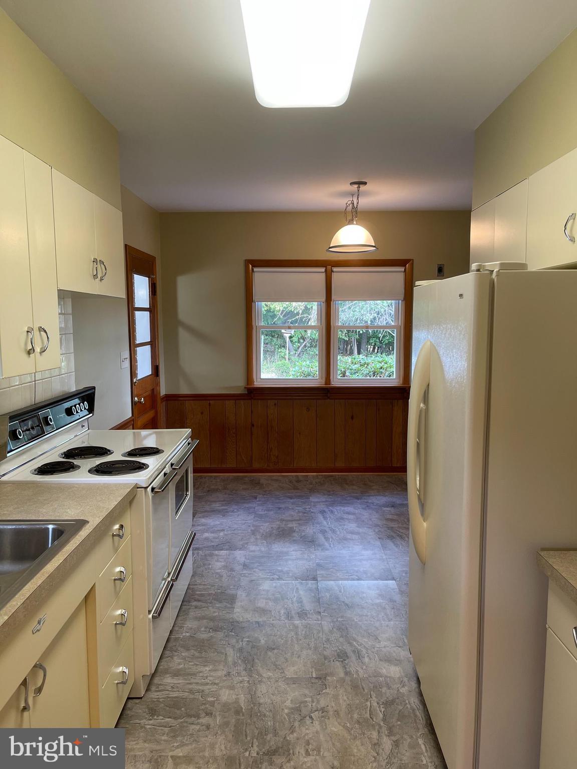 1670 Florence Road Mount Airy, MD 21771 - Photo 14 of 20 a kitchen with a stove a refrigerator and a stove top oven