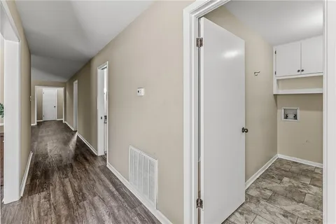a view of a hallway with wooden floor