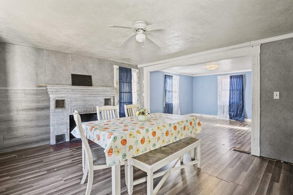 15 White Street Lunenburg, MA 01462 - Photo 16 of 29 a dining room with a table chairs and a fireplace