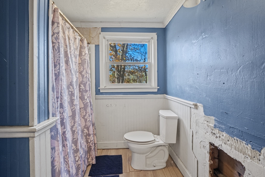 15 White Street Lunenburg, MA 01462 - Photo 20 of 29 a white toilet sitting next to a window