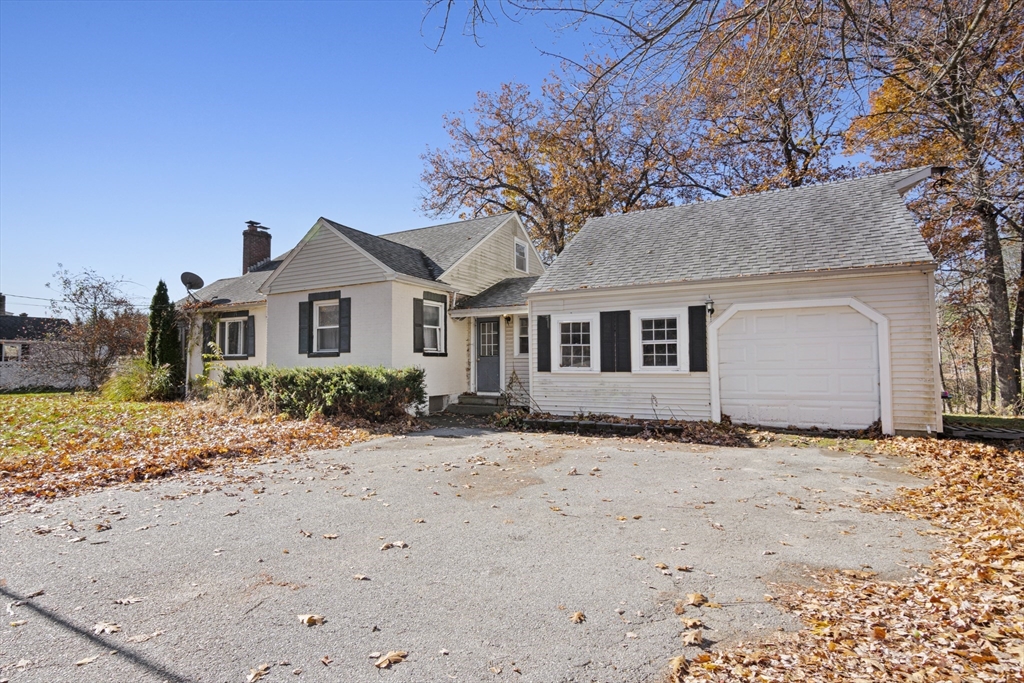 15 White Street Lunenburg, MA 01462 - Photo 3 of 29 a front view of a house with a dirt yard and a large tree