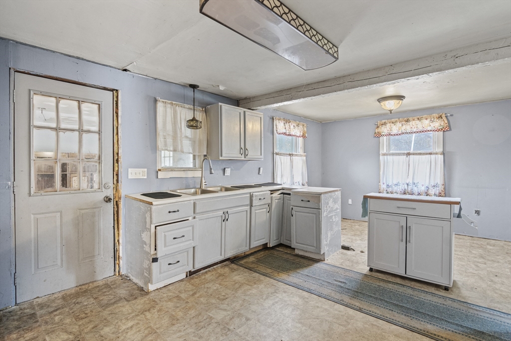 15 White Street Lunenburg, MA 01462 - Photo 6 of 29 a large white kitchen with sink and cabinets
