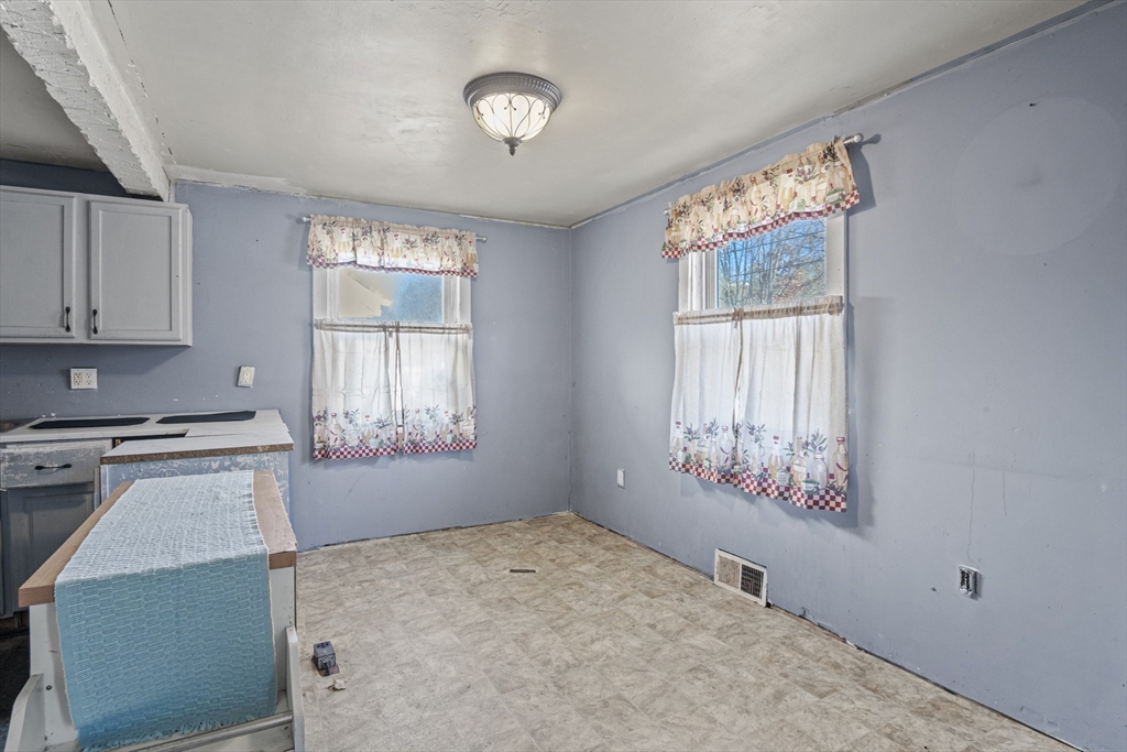 15 White Street Lunenburg, MA 01462 - Photo 10 of 29 a kitchen with stainless steel appliances a stove a refrigerator white cabinets and a window