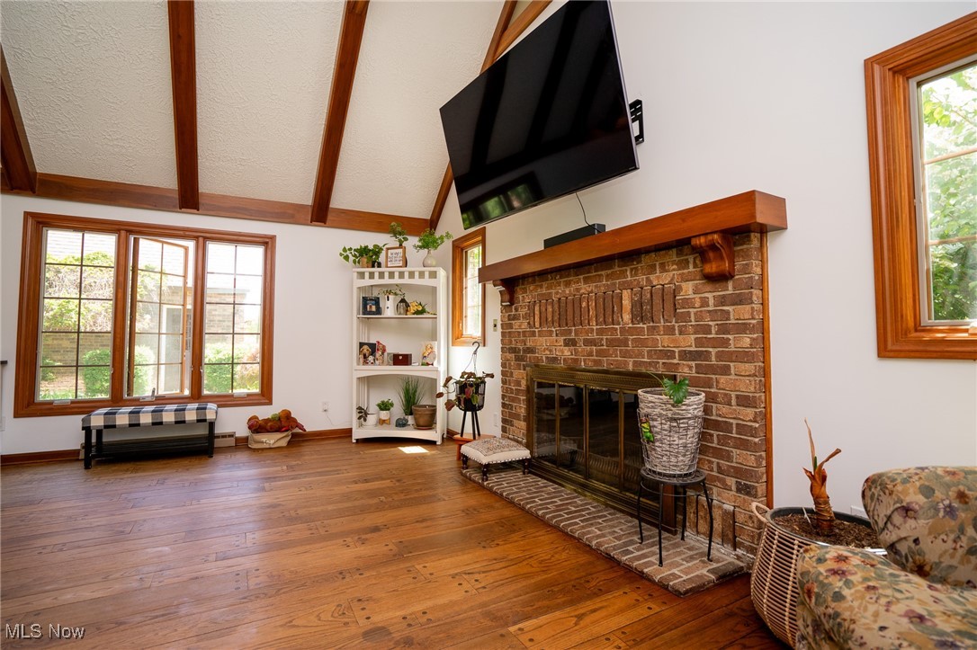 7780 Knauf Road Canfield, OH 44406 - Photo 6 of 48 Great room featuring hardwood / wood-style floors, a brick fireplace, and baseboards