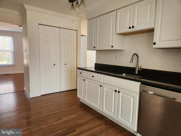 a kitchen with stainless steel appliances granite countertop a refrigerator and a stove