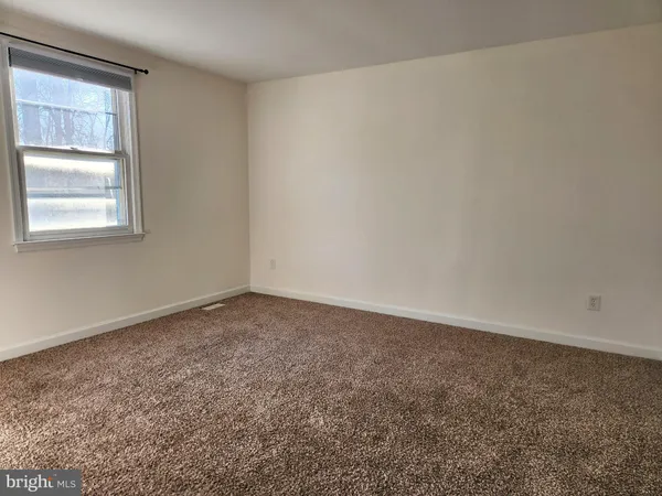 a view of an empty room and a window